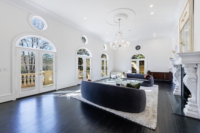 living room featuring dark wood-style floors, a wealth of natural light, french doors, and a premium fireplace