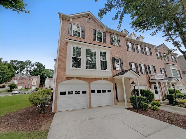 2231 Mill Garden Pl, Buford, GA 30519 - view of front of house featuring a garage, concrete driveway, brick siding, and a front yard