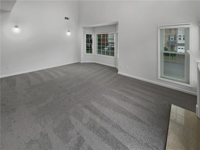2231 Mill Garden Pl, Buford, GA 30519 - unfurnished living room with a high ceiling, ceiling fan, carpet, a fireplace, and crown molding