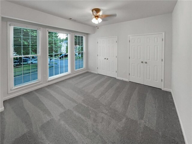 2231 Mill Garden Pl, Buford, GA 30519 - unfurnished bedroom with two closets, carpet flooring, and ceiling fan