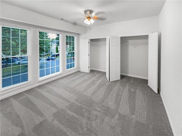2231 Mill Garden Pl, Buford, GA 30519 - unfurnished living room with carpet flooring, a towering ceiling, healthy amount of natural light, a fireplace with flush hearth, and ceiling fan