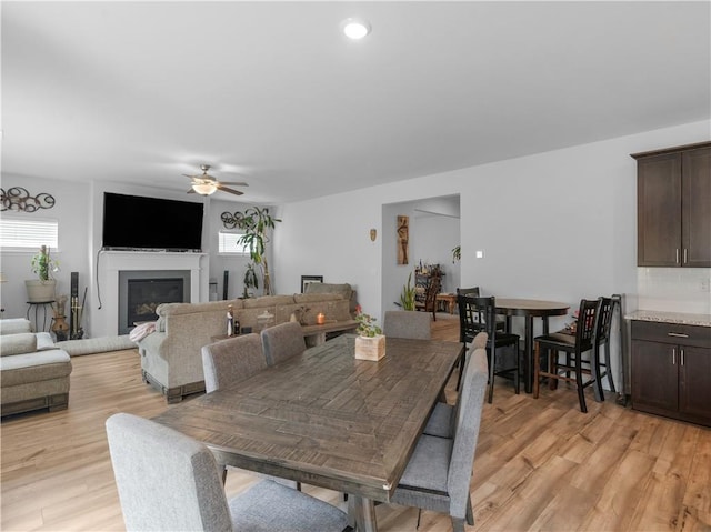 dining space with ceiling fan, light wood-type flooring, and plenty of natural light