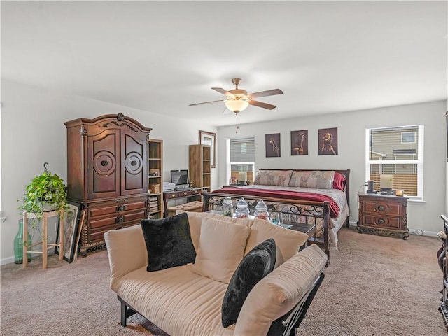 bedroom featuring light carpet, multiple windows, and ceiling fan