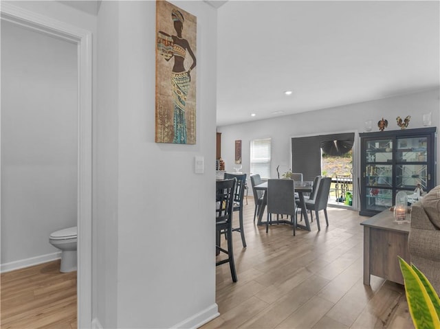 hallway with light hardwood / wood-style flooring