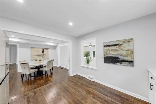 dining space featuring ceiling fan and dark wood-type flooring