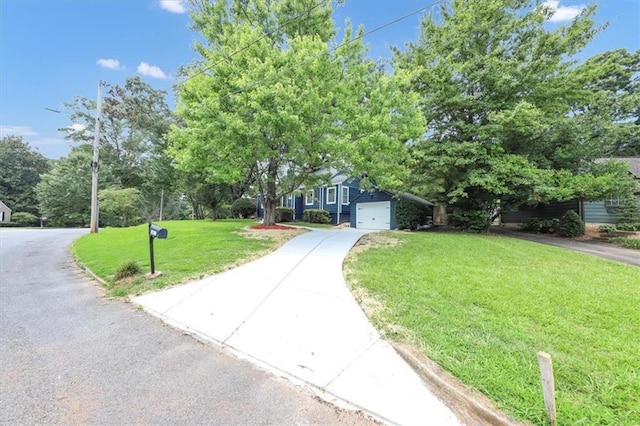 view of front of house featuring a front yard and a garage