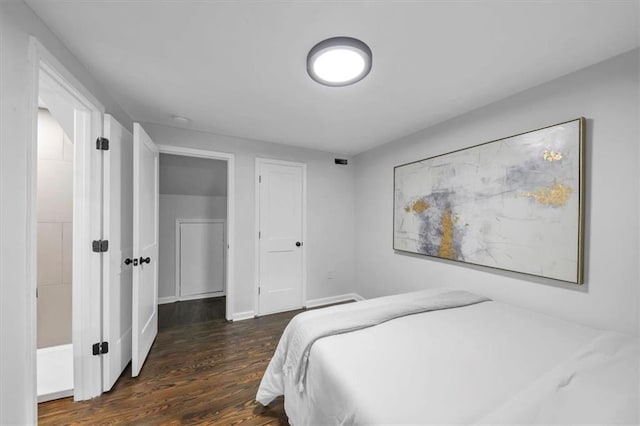 bedroom with dark hardwood / wood-style floors