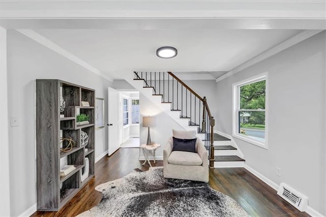 living area featuring crown molding and dark wood-type flooring