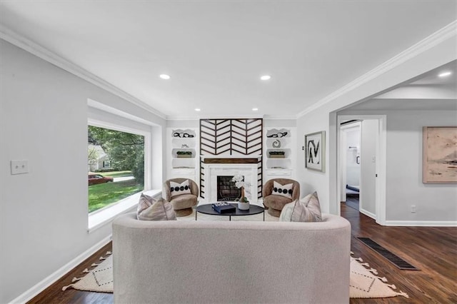 living room with crown molding, built in features, and dark wood-type flooring