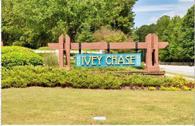 community sign featuring a lawn