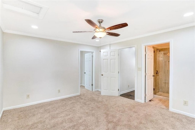 unfurnished bedroom with baseboards, carpet flooring, attic access, and ornamental molding