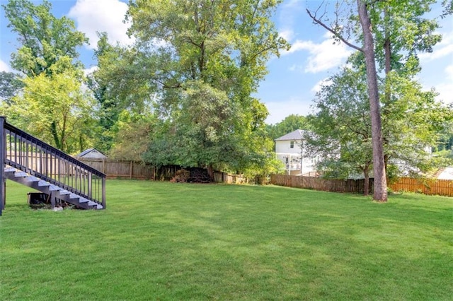 view of yard with stairway and a fenced backyard
