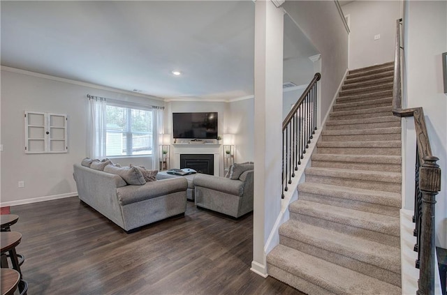 living area with a fireplace, baseboards, stairway, dark wood-style floors, and crown molding