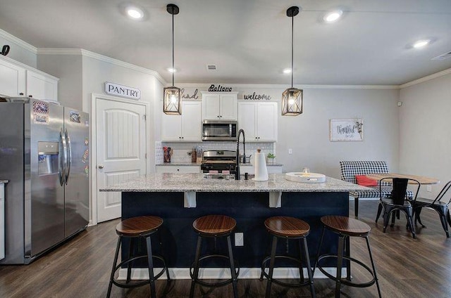 kitchen featuring ornamental molding, appliances with stainless steel finishes, dark wood-style flooring, and white cabinetry