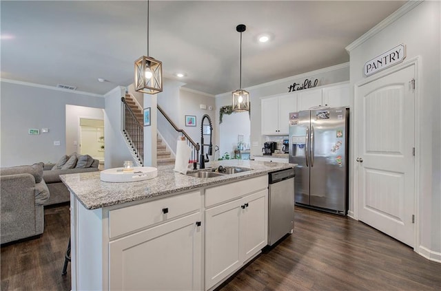 kitchen with stainless steel appliances, a sink, visible vents, dark wood-style floors, and crown molding