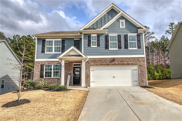 craftsman house with board and batten siding, brick siding, driveway, and a garage