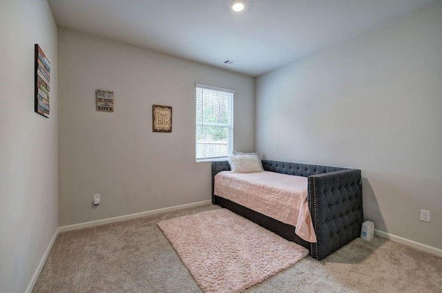 carpeted bedroom featuring visible vents and baseboards