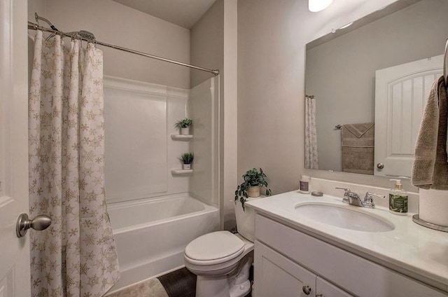 full bathroom featuring shower / bath combo, vanity, and toilet