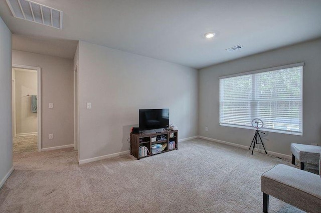 sitting room with carpet, visible vents, and baseboards