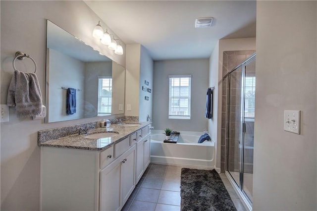 full bathroom with a garden tub, tile patterned floors, a sink, and a stall shower