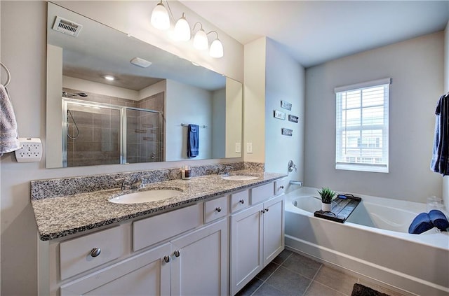 full bathroom with a stall shower, visible vents, a sink, and tile patterned floors