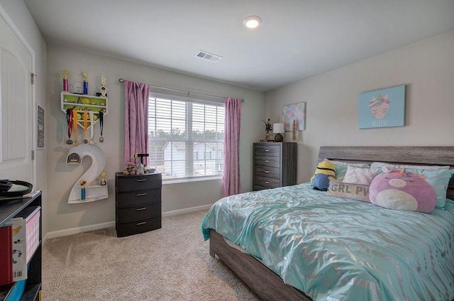 carpeted bedroom with visible vents and baseboards