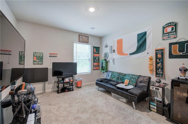 living room featuring carpet, visible vents, and baseboards