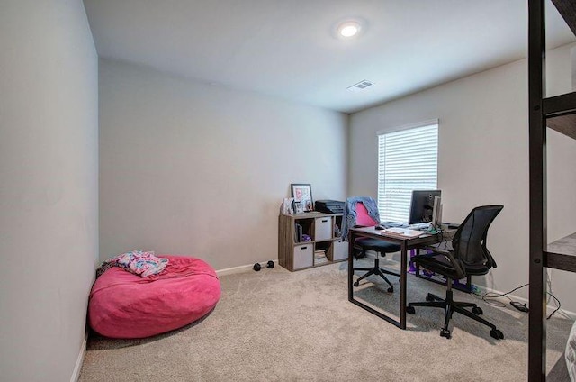 carpeted home office featuring visible vents and baseboards