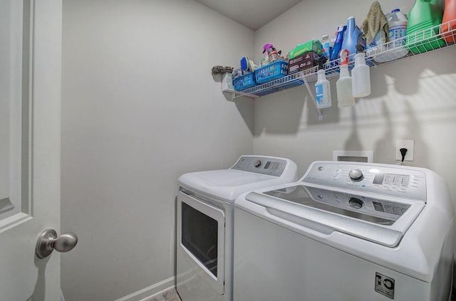 laundry room featuring laundry area, washer and clothes dryer, and baseboards