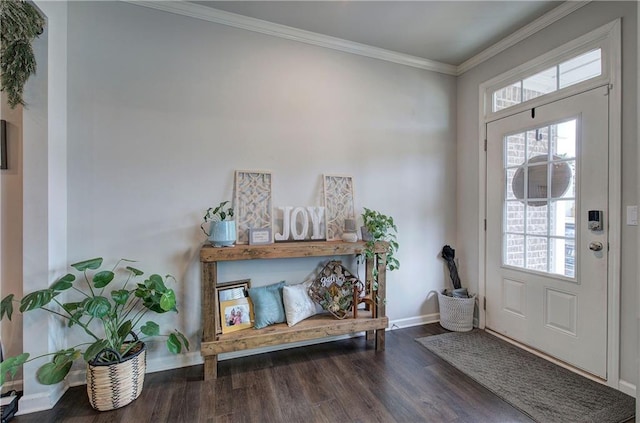 entrance foyer featuring ornamental molding, wood finished floors, and baseboards