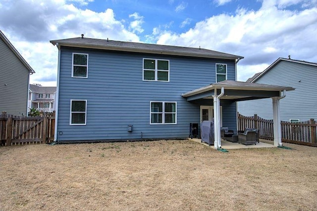 back of house featuring a patio area, a fenced backyard, and a lawn