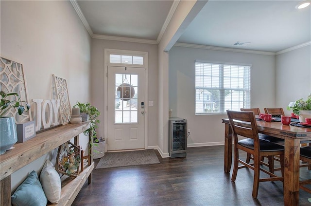 foyer entrance with plenty of natural light, wine cooler, and ornamental molding