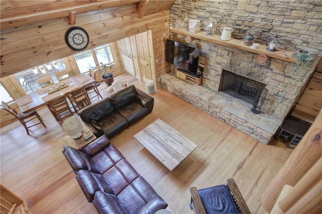 128 Rushing Waters Ct, Talking Rock, GA 30175 - living area featuring hardwood / wood-style flooring, a fireplace, beam ceiling, and wood walls