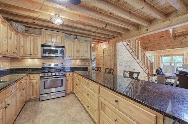 128 Rushing Waters Ct, Talking Rock, GA 30175 - kitchen featuring appliances with stainless steel finishes, a wooden ceiling with exposed beams, wooden walls, light tile patterned flooring, and light brown cabinetry