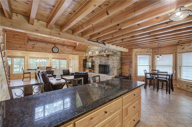 128 Rushing Waters Ct, Talking Rock, GA 30175 - kitchen with wood walls, a fireplace, beam ceiling, light tile patterned flooring, and open floor plan