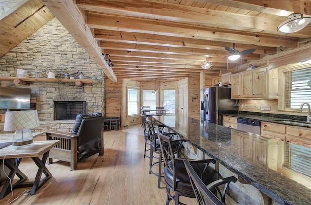 128 Rushing Waters Ct, Talking Rock, GA 30175 - kitchen with appliances with stainless steel finishes, a wooden ceiling with exposed beams, healthy amount of natural light, light wood finished floors, and a breakfast bar area