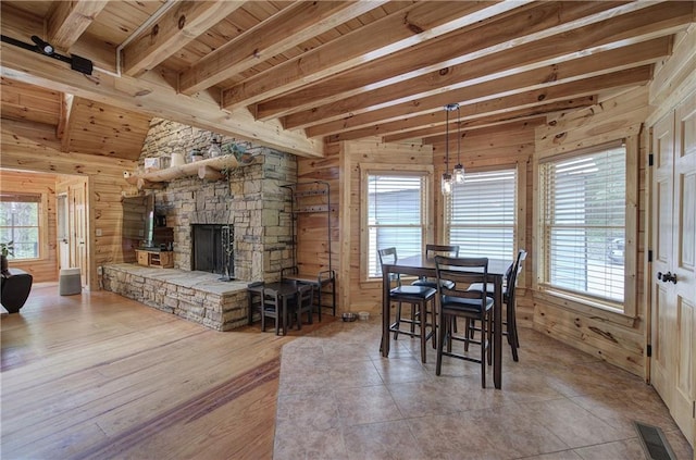 128 Rushing Waters Ct, Talking Rock, GA 30175 - dining area featuring wooden walls, a wood ceiling with exposed beams, a stone fireplace, and wood finished floors
