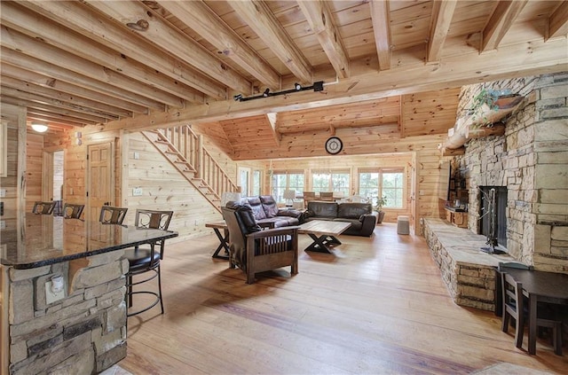128 Rushing Waters Ct, Talking Rock, GA 30175 - living area with wooden walls, light wood-style floors, stairway, a wood ceiling with exposed beams, and a fireplace