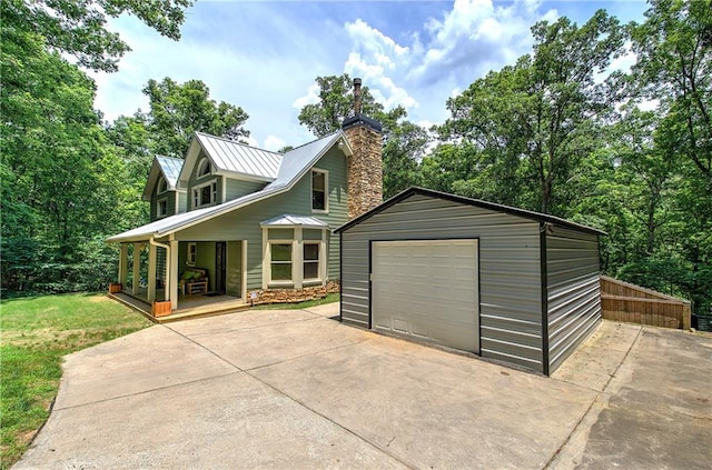 128 Rushing Waters Ct, Talking Rock, GA 30175 - view of front of house with driveway, a porch, a garage, an outdoor structure, and a metal roof