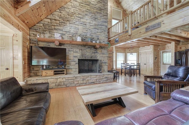 128 Rushing Waters Ct, Talking Rock, GA 30175 - living room with high vaulted ceiling, wood-type flooring, wooden walls, a stone fireplace, and wooden ceiling
