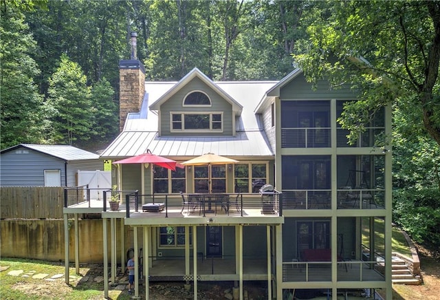 128 Rushing Waters Ct, Talking Rock, GA 30175 - back of house featuring a sunroom, a metal roof, a standing seam roof, and a chimney