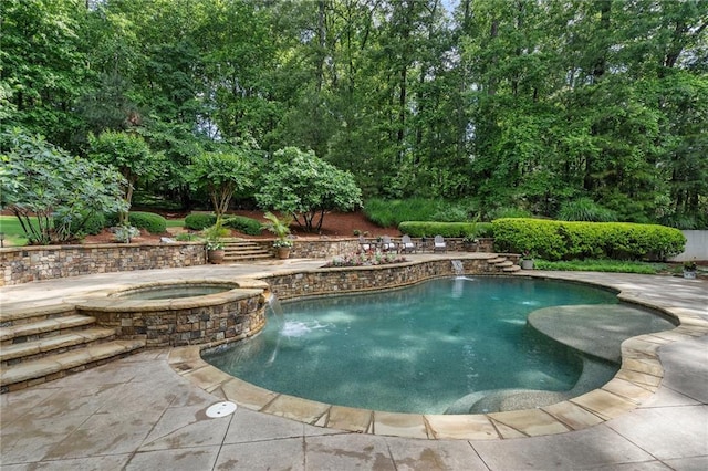 view of swimming pool featuring a pool with connected hot tub and a patio