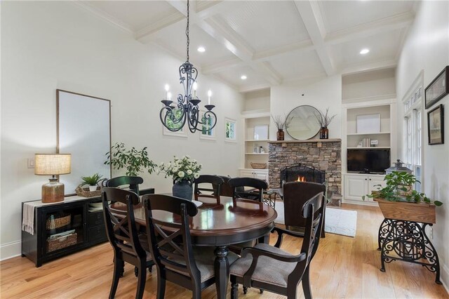 dining area with beam ceiling, light wood-style floors, a fireplace, recessed lighting, and coffered ceiling