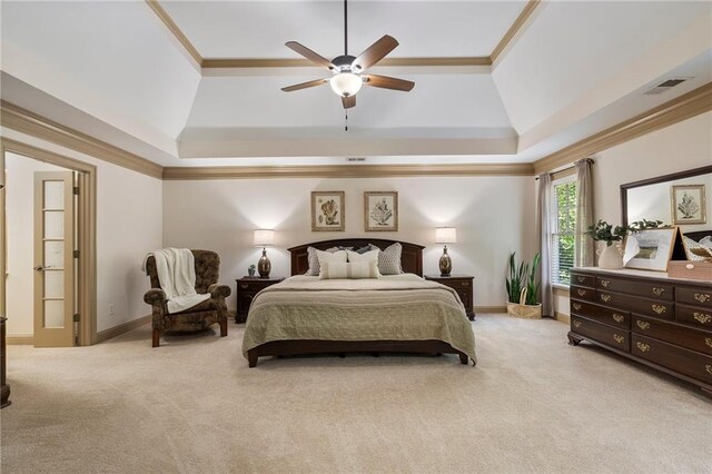 bedroom with light colored carpet, a raised ceiling, ornamental molding, and ceiling fan