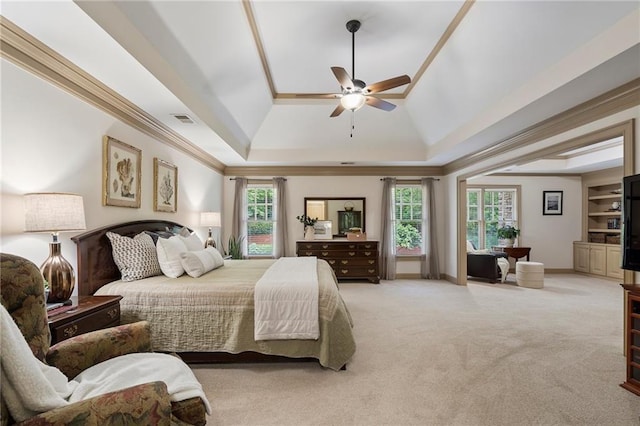 bedroom with a raised ceiling, multiple windows, carpet, and ceiling fan