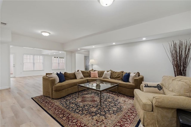 living area with light wood-style floors and recessed lighting