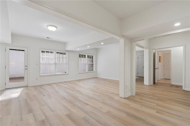 unfurnished living room featuring recessed lighting, baseboards, and light wood-type flooring