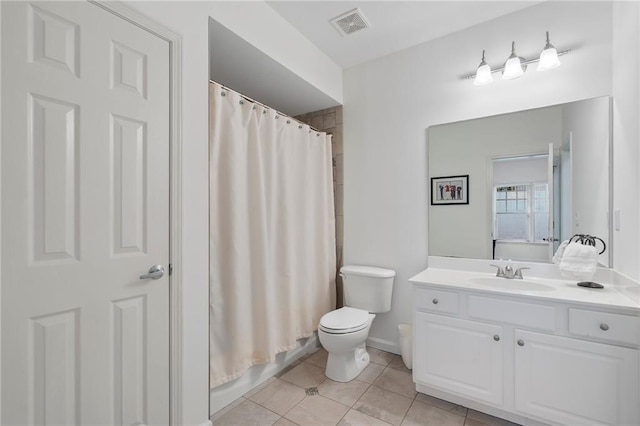 bathroom featuring toilet, tile patterned flooring, vanity, and baseboards