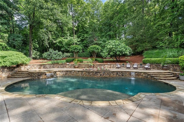 view of swimming pool featuring a patio area and a pool with connected hot tub