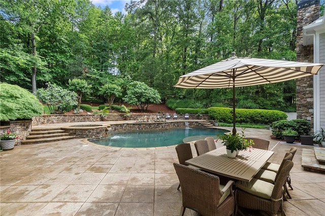 view of pool with a patio area and a pool with connected hot tub